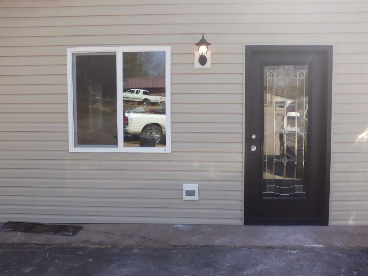 New siding, window and entry door on the side of an addition in McMinnville
