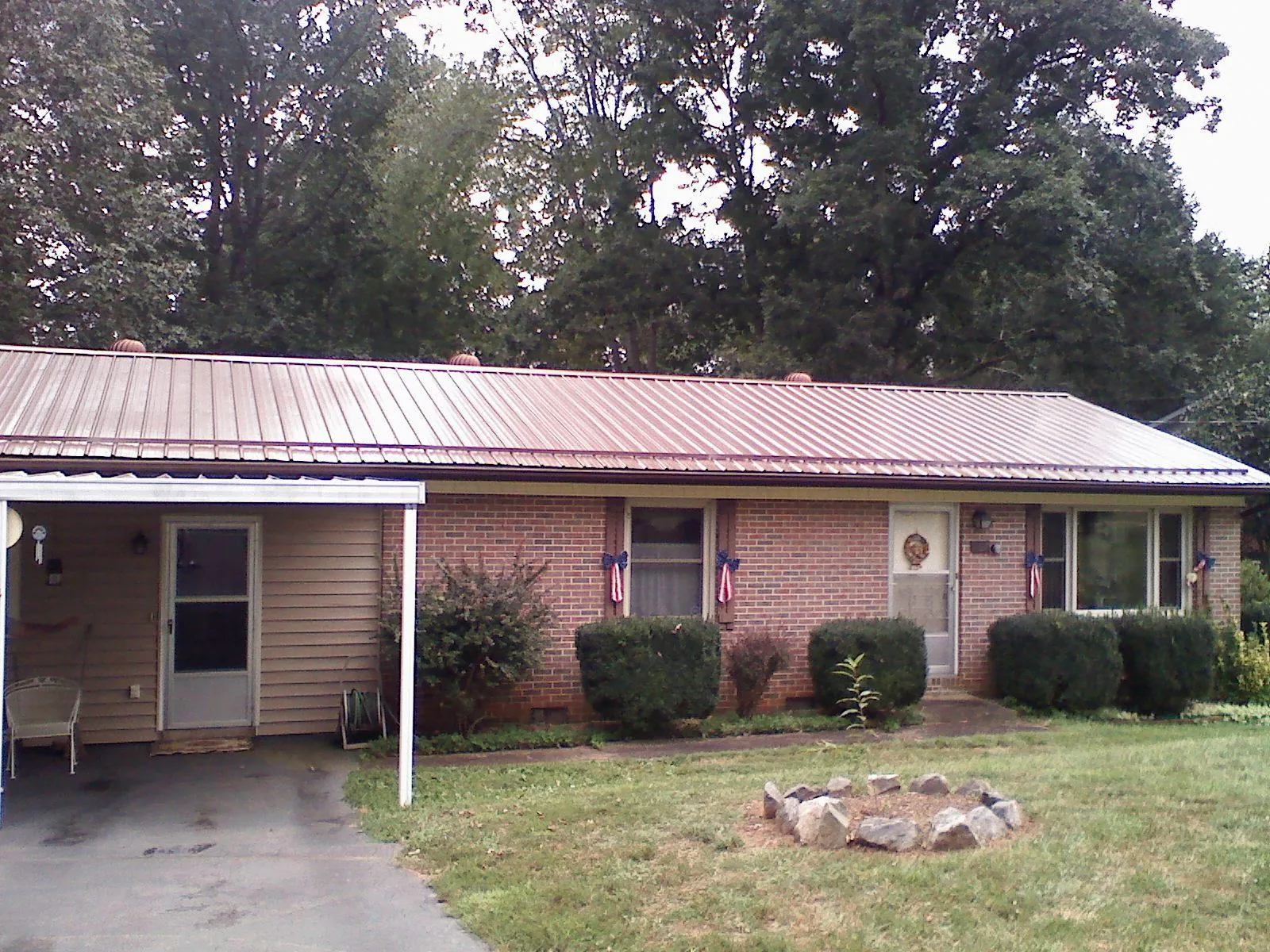Bronze metal roof and carport on a brick ranch home — Roof Repair work by our crew in McMinnville